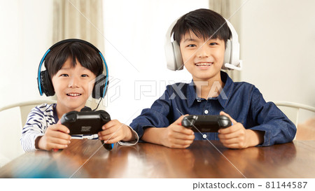 Boy wearing a headset and enjoying video games 81144587