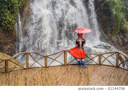 A female tourist dressed in the traditional dress of the inhabitants of the Vietnamese mountains, the Hmong. Woman in Sapa in the fog, Northwest Vietnam. Vietnam travel concept. UNESCO heritage A female tourist dressed in the traditional dress of the inhabitants of the Vietnamese mountains, the Hmong. Woman in Sapa in the fog, Northwest Vietnam. Vietnam travel concept. UNESCO heritage 81144706