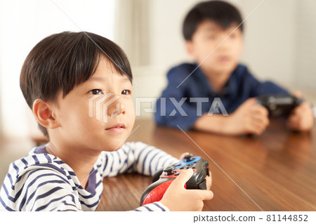Boy playing on a home video game console Boy playing on a home video game console 81144852
