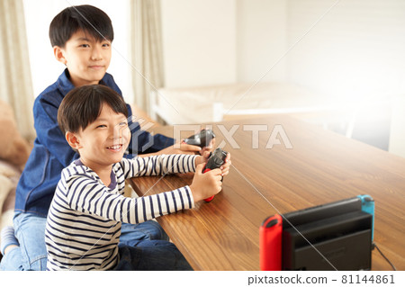 Two boys enjoying video games at home 81144861