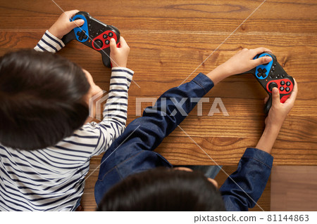 Hands of a boy with a gamepad 81144863