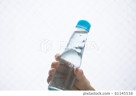 在炎熱的一天,手拿著 ramune 對著太陽 在炎熱的一天,手拿著 ramune 對著太陽 81145538