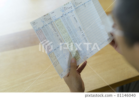 Men looking at the results of the health examination Men looking at the results of the health examination 81146040