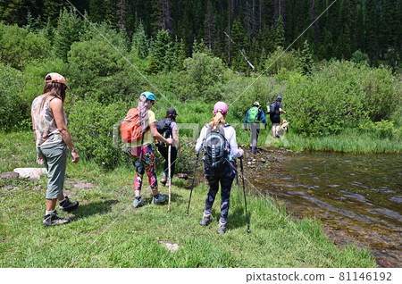 Hikers in shallow water on Hassell Lake Trail in Arapaho Nat'l Forest, Colorado. Hikers in shallow water on Hassell Lake Trail in Arapaho Nat'l Forest, Colorado. 81146192