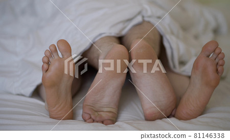 Closeup of young beautiful and loving couple play and dance their feet 81146338