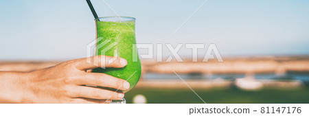 Green juice detox healthy food woman serving or taking smoothie glass of spinach spirulina weight loss. Panoramic banner for healthy eating 81147176