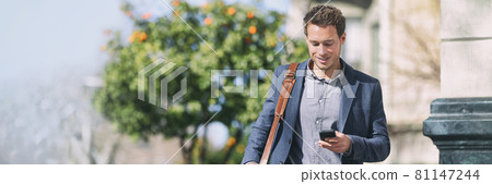 Banner phone man using cellphone texting on city commute street banner panorama. Panoramic view of businessman walking holding mobile phone 81147244