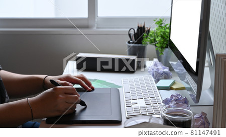 Man graphic designer working with modern computer and graphic tablet. Man graphic designer working with modern computer and graphic tablet. 81147491