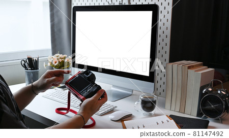 Man photographer checking photos on digital camera. 81147492