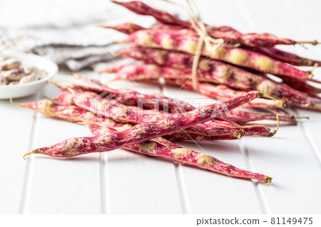 Cranberry beans. Beans pods on white table. 81149475