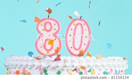 Colorful tasty birthday cake with candles shaped like the number 80. 81150134