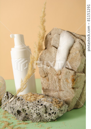 Facial product sample on a stone and spikelet. A set of cosmetics products with natural materials. 81151291