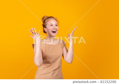 Horizontal portrait of young laughing girl isolated on yellow studio background. Concept of human emotions, facial expression, youth, sales, ad. 81152200