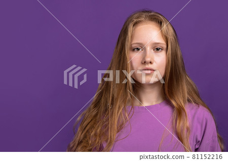 Half-length portrait of young beautiful girl isolated on purple studio background. Concept of human emotions, facial expression, youth, sales, ad. Half-length portrait of young beautiful girl isolated on purple studio background. Concept of human emotions, facial expression, youth, sales, ad. 81152216