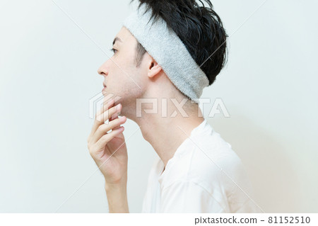 Young man checking skin condition Young man checking skin condition 81152510