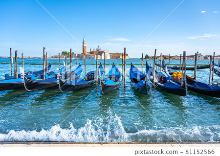 Moored gondolas at St. Mark Square with Church of San Giorgio Maggiore on background. Venice, Italy 81152566