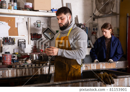 Young man worker during working process in workshop 81153901