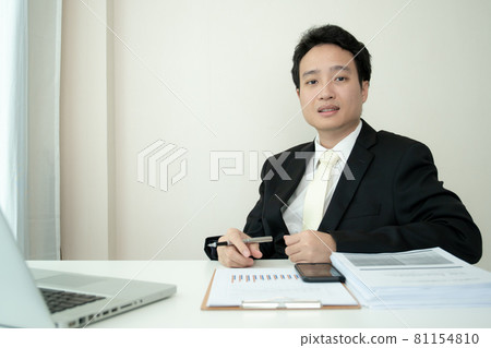 Asian young businessman working at home office. Asian young businessman working at home office. 81154810