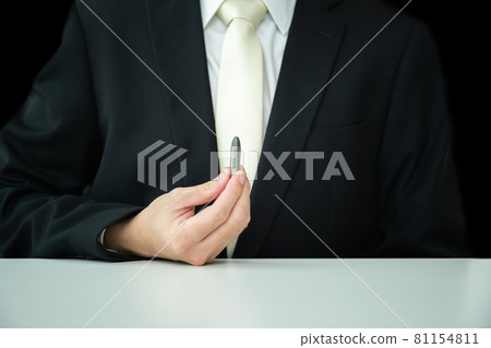 Unrecognizable businessman showing a .38 ammunition. Unrecognizable businessman showing a .38 ammunition. 81154811