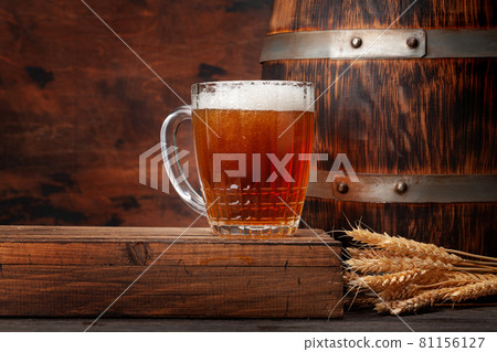 Mug of light lager beer and old wooden barrel 81156127