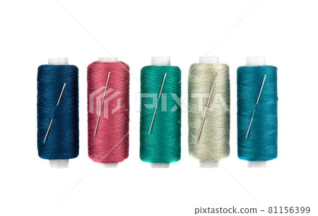 Row of spools of thread of different colors and sewing needles inserted into the spools. Row of spools of thread of different colors and sewing needles inserted into the spools. 81156399