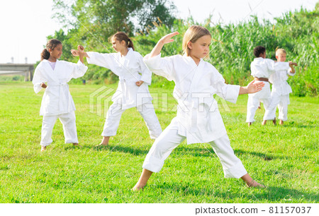 Girl in kimono posing during outdoor training 81157037