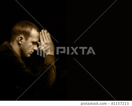 Young man praying Young man praying 81157213