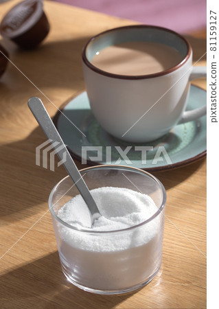 Spoon in sweetener stevia on a background of coffee with milk 81159127