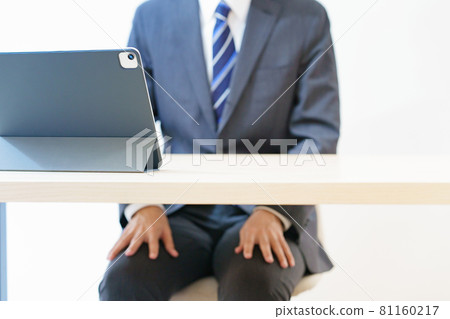 A man in a suit attending an online interview, meeting, or meeting with a tense look 81160217