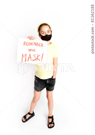 A schoolgirl in a black protective mask draws attention to the correctness and compulsory wearing of protective masks. A schoolgirl in a black protective mask draws attention to the correctness and compulsory wearing of protective masks. 81162188