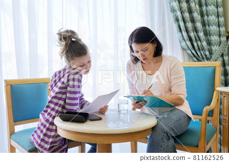 Pre-adolescent girl at consultation with social worker in office Pre-adolescent girl at consultation with social worker in office 81162526
