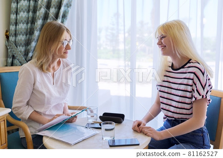 Psychologist consultation, teenage girl at meeting with psychologist in office Psychologist consultation, teenage girl at meeting with psychologist in office 81162527