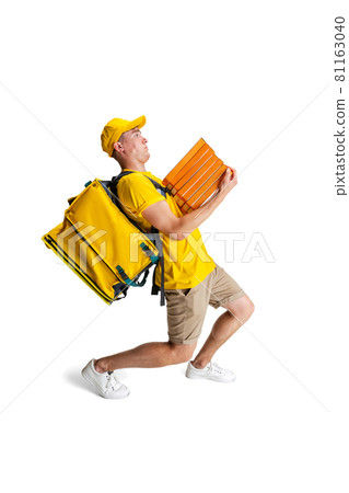 Portrait of delivery man in yellow uniform deliver order of pizza to client. custom isolated on white background. Concept of convenience, speed, comfort, safety, service. Portrait of delivery man in yellow uniform deliver order of pizza to client. custom isolated on white background. Concept of convenience, speed, comfort, safety, service. 81163040