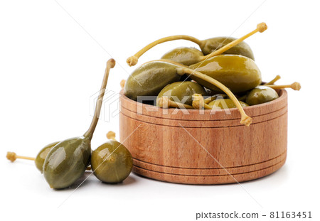 Pickled capers in a plate on a white background. Isolated 81163451
