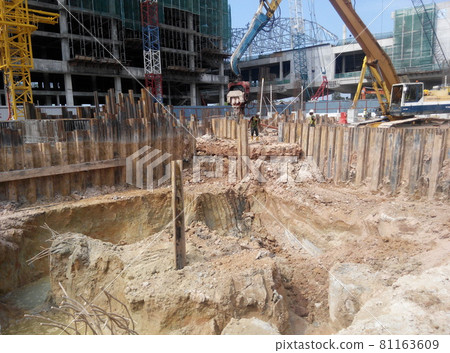 MALACCA, MALAYSIA -SEPTEMBER 25, 2015: Temporary steel sheet retaining wall using sheet pile cofferdam method holding outside soil from collapse into pile pits.    81163609