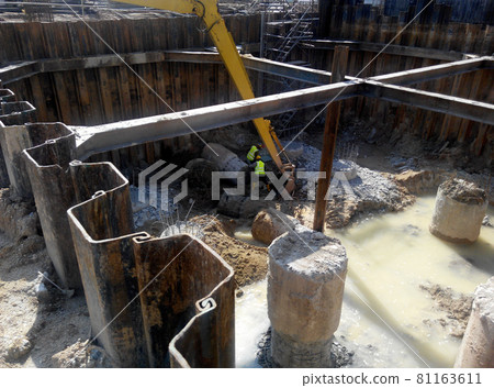 MALACCA, MALAYSIA -SEPTEMBER 25, 2015: Temporary steel sheet retaining wall using sheet pile cofferdam method holding outside soil from collapse into pile pits.    81163611