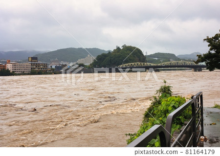 Muddy stream of the Kiso River that has become muddy and flooded. Flooding and flooding of the river 81164179