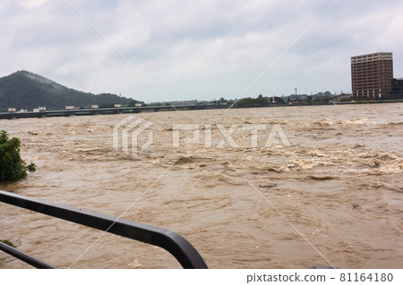 Muddy stream of the Kiso River that has become muddy and flooded. Flooding and flooding of the river Muddy stream of the Kiso River that has become muddy and flooded. Flooding and flooding of the river 81164180