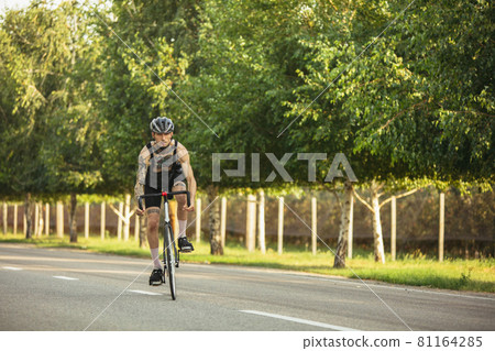 Young male cyclist riding a road bike in summer day. Action, motion concept 81164285