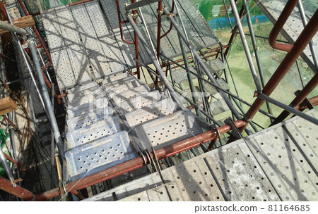 MALACCA, MALAYSIA -SEPTEMBER 23, 2016: Temporary access and staircase supported by reinforced scaffolding at the construction site. Used by construction workers.   81164685