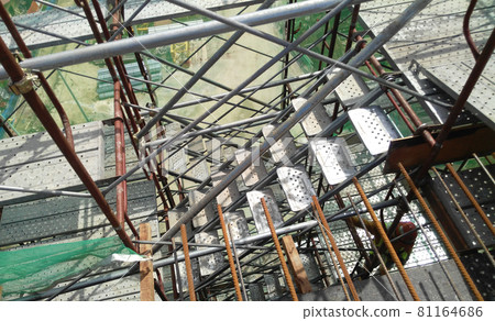 MALACCA, MALAYSIA -SEPTEMBER 23, 2016: Temporary access and staircase supported by reinforced scaffolding at the construction site. Used by construction workers. MALACCA, MALAYSIA -SEPTEMBER 23, 2016: Temporary access and staircase supported by reinforced scaffolding at the construction site. Used by construction workers. 81164686