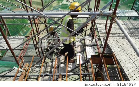 MALACCA, MALAYSIA -SEPTEMBER 23, 2016: Temporary access and staircase supported by reinforced scaffolding at the construction site. Used by construction workers.   81164687