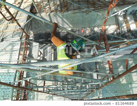 MALACCA, MALAYSIA -SEPTEMBER 23, 2016: Temporary access and staircase supported by reinforced scaffolding at the construction site. Used by construction workers.   81164689