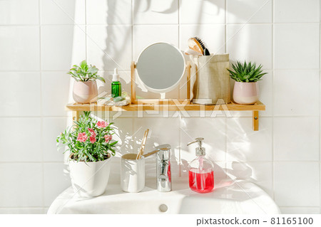 Bamboo shelf with toiletries in white modern bathroom Bamboo shelf with toiletries in white modern bathroom 81165100