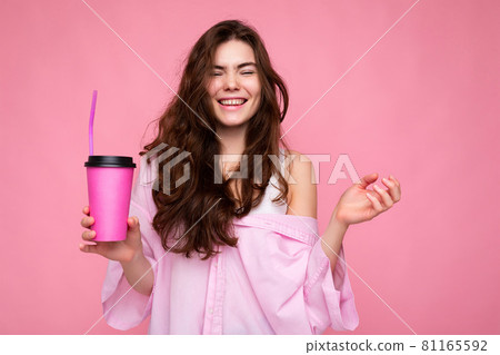 Beautiful young positive brunette woman wearing casual stylish clothes isolated over colorful Beautiful young positive brunette woman wearing casual stylish clothes isolated over colorful 81165592