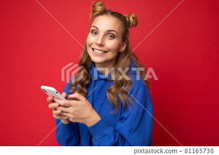 Photo shot of attractive positive good looking young woman wearing casual stylish outfit poising 81165738