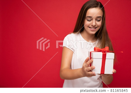 Photo of beautiful positive happy little female child isolated over red bacground wearing casual Photo of beautiful positive happy little female child isolated over red bacground wearing casual 81165845