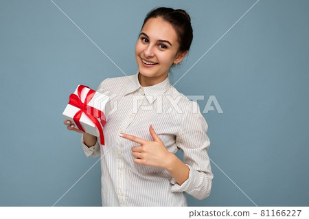 Beautiful happy young brunette woman isolated over colourful background wall wearing stylish casual 81166227