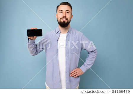 Handsome happy cool young man good looking wearing casual stylish clothes standing isolated over Handsome happy cool young man good looking wearing casual stylish clothes standing isolated over 81166479