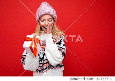Photo shot of pretty positive surprised young blond woman isolated over colourful background wall Photo shot of pretty positive surprised young blond woman isolated over colourful background wall 81166500